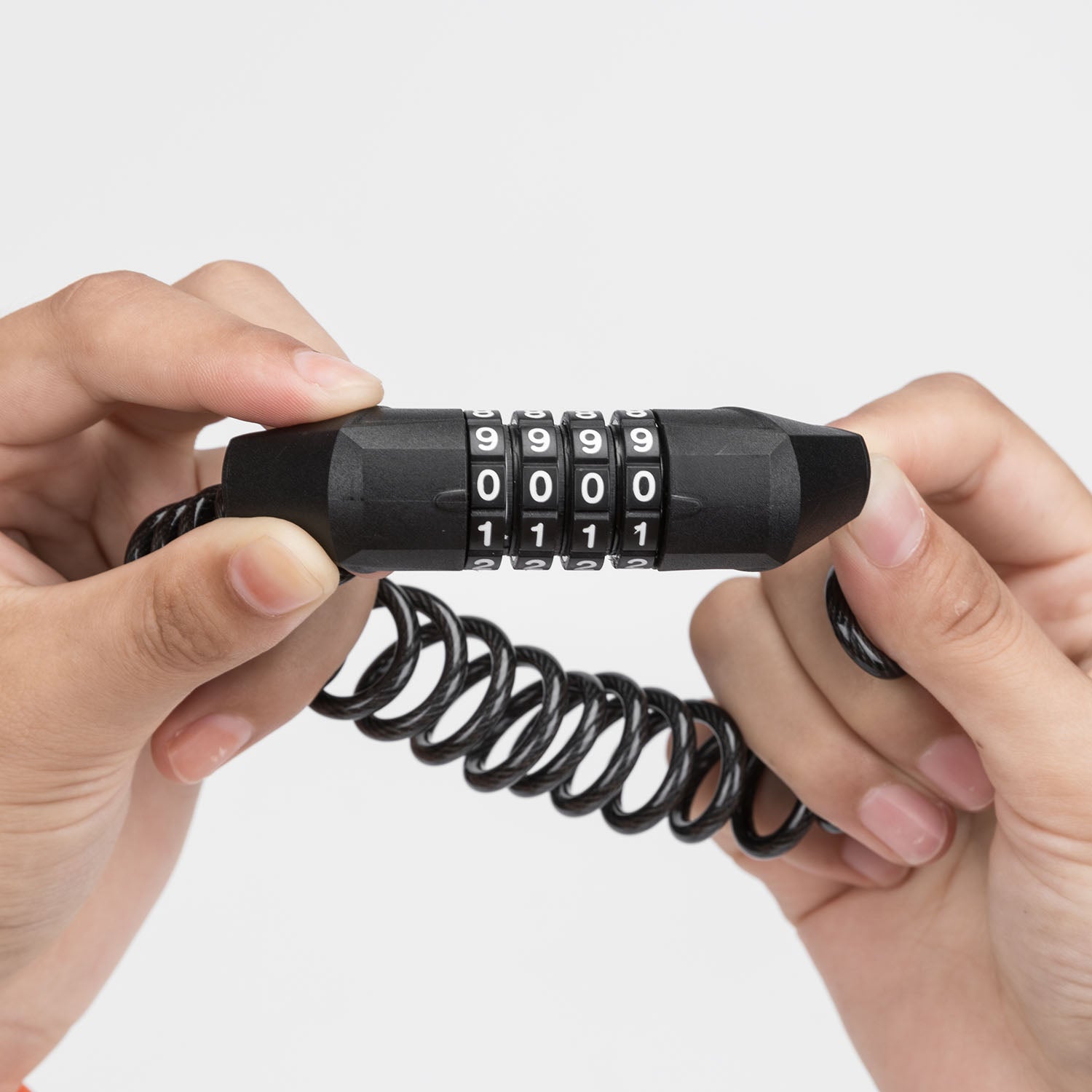 Image of hands holding the 4 digit combination lock