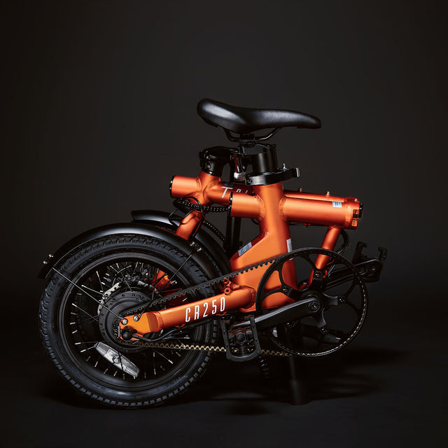 Image of the orange Compact Rider folded up compactly