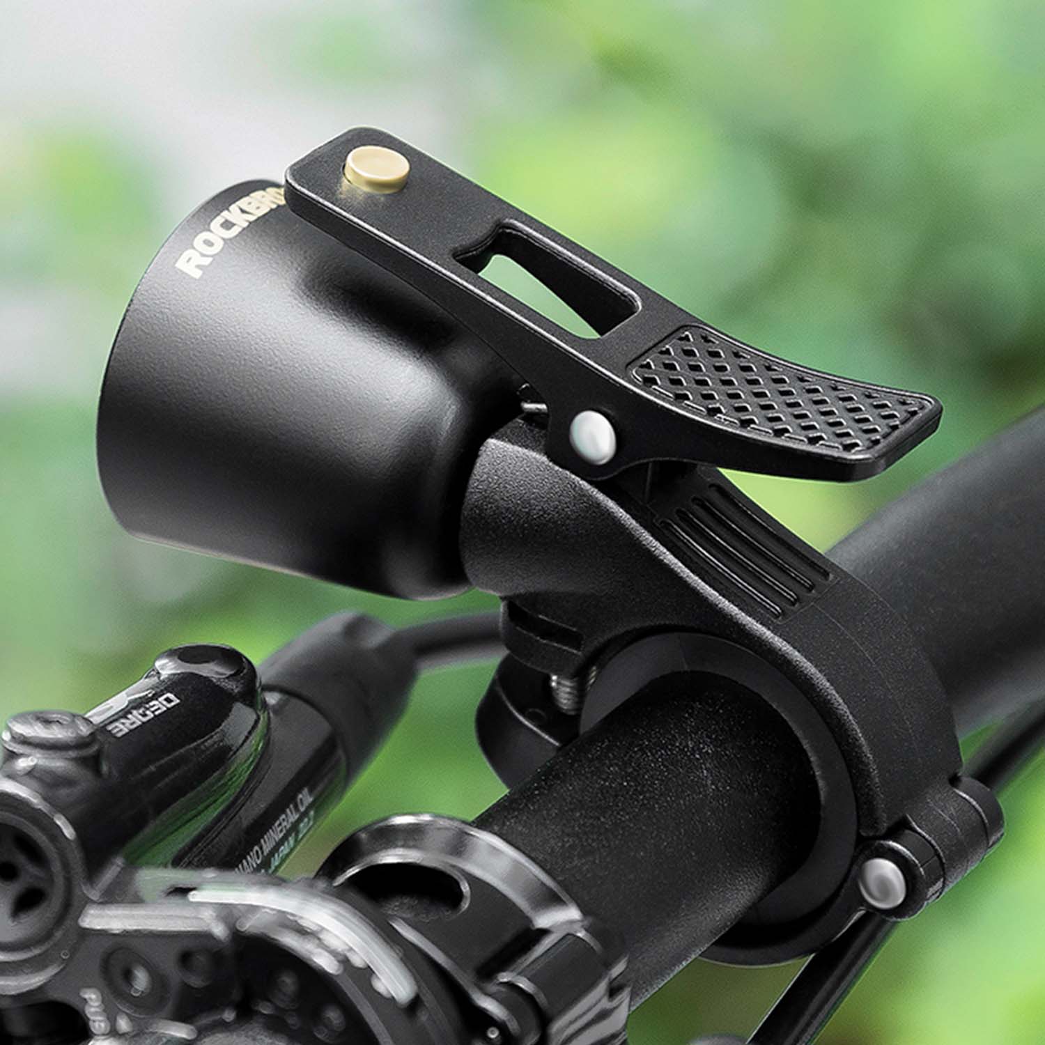 Image of a bicycle bell attached to the handles of a bike