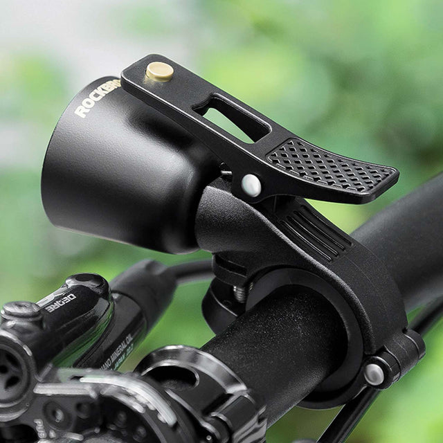 Image of a bicycle bell attached to the handles of a bike