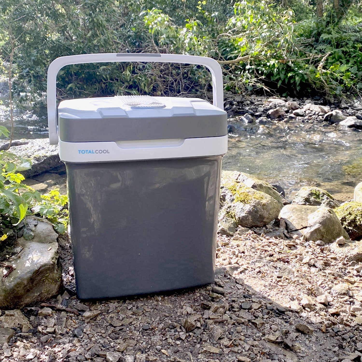 Image of the grey Eco-chill 24 outside next to a stream