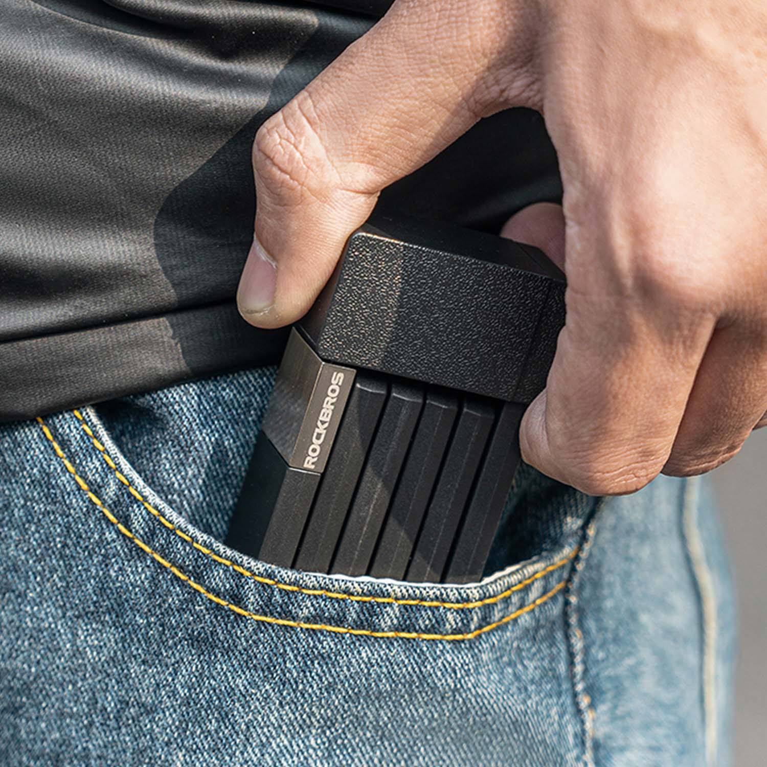 an image of the folding lock being compact enough to fit inside of a trouser pocket