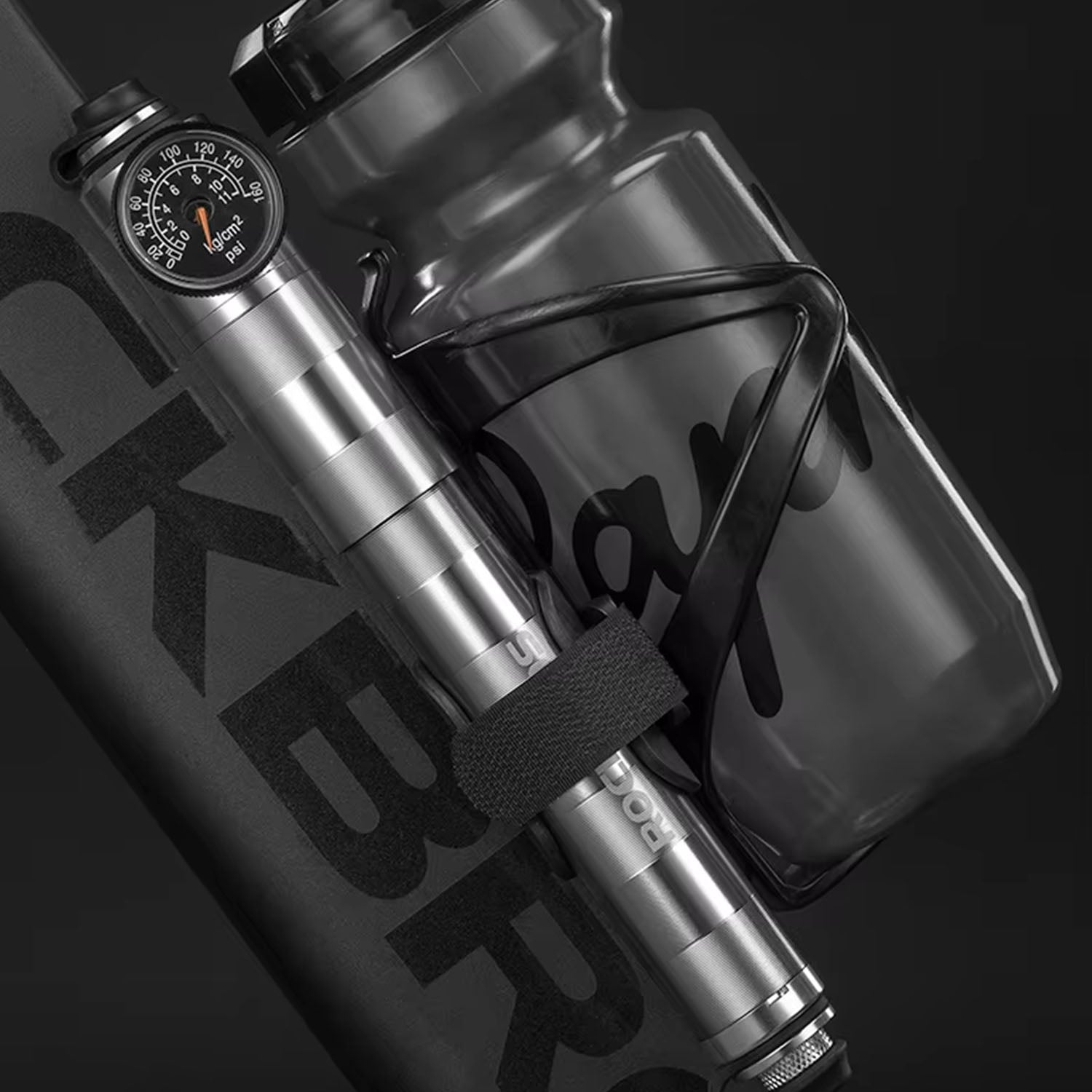 Image of the manual bike pump being attached to the bike alongside the frame mounted bottle holder