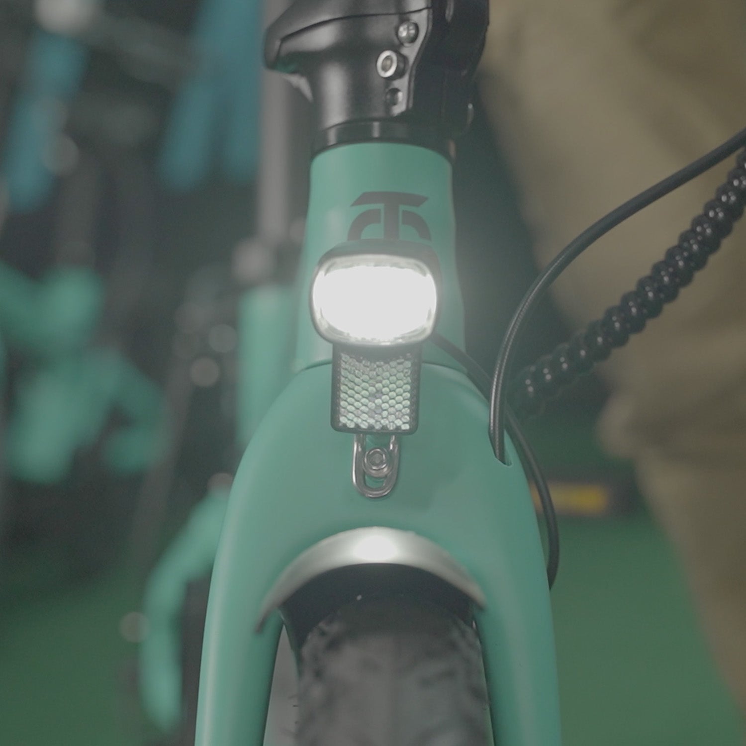 Image of the Carbon Fibre 250 folding E-Bikes front light in operation