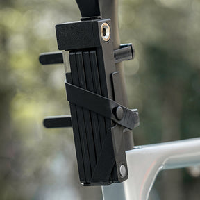 Image of the folding lock attached to the seatpost of a bike inside of the holster