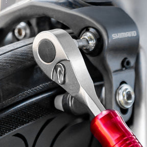 Image of the ratchet wrench being used to tighten brake mounts
